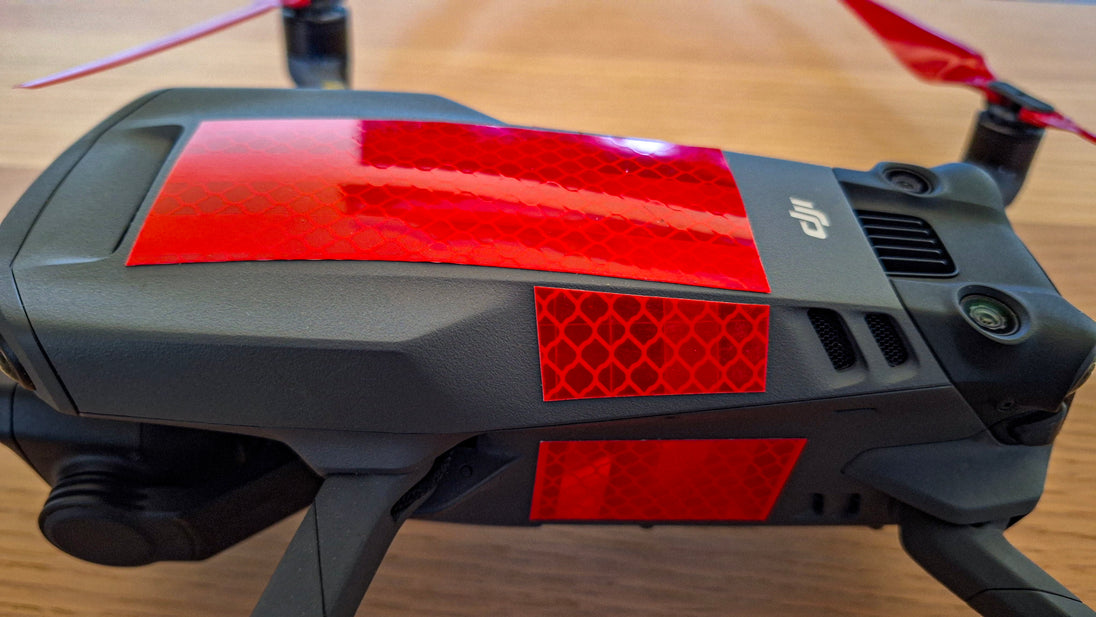 DJI drone with highly reflective red tape to deter bird attacks and enhance visibility.