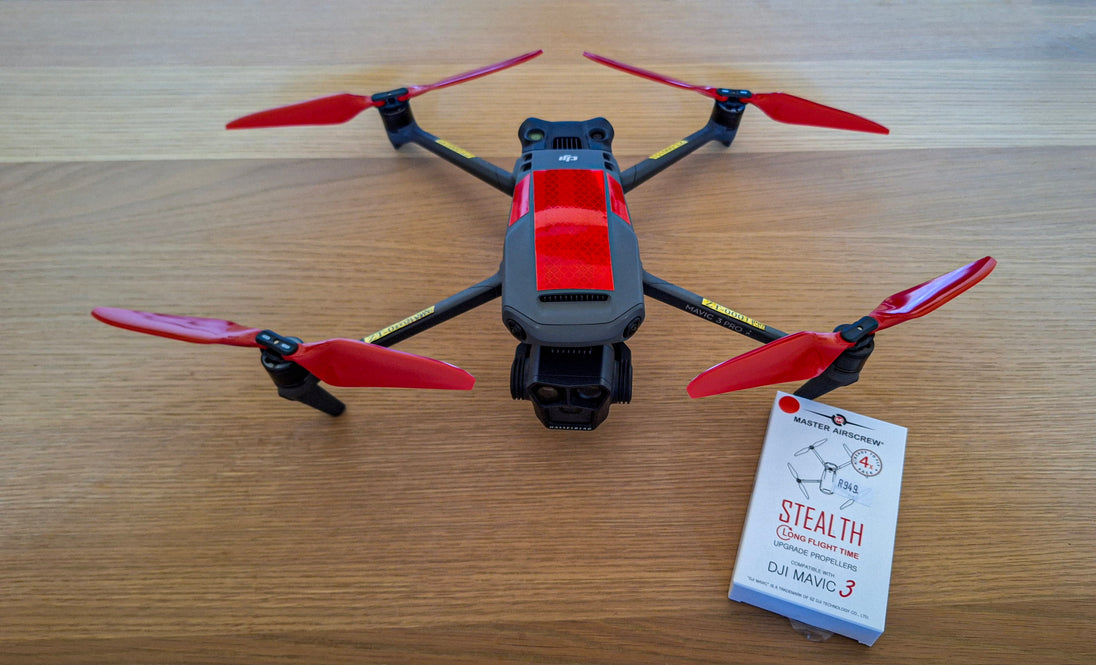 Image of a DJI Mavic Pro drone with red propellers and a package of reflective tape for bird protection.