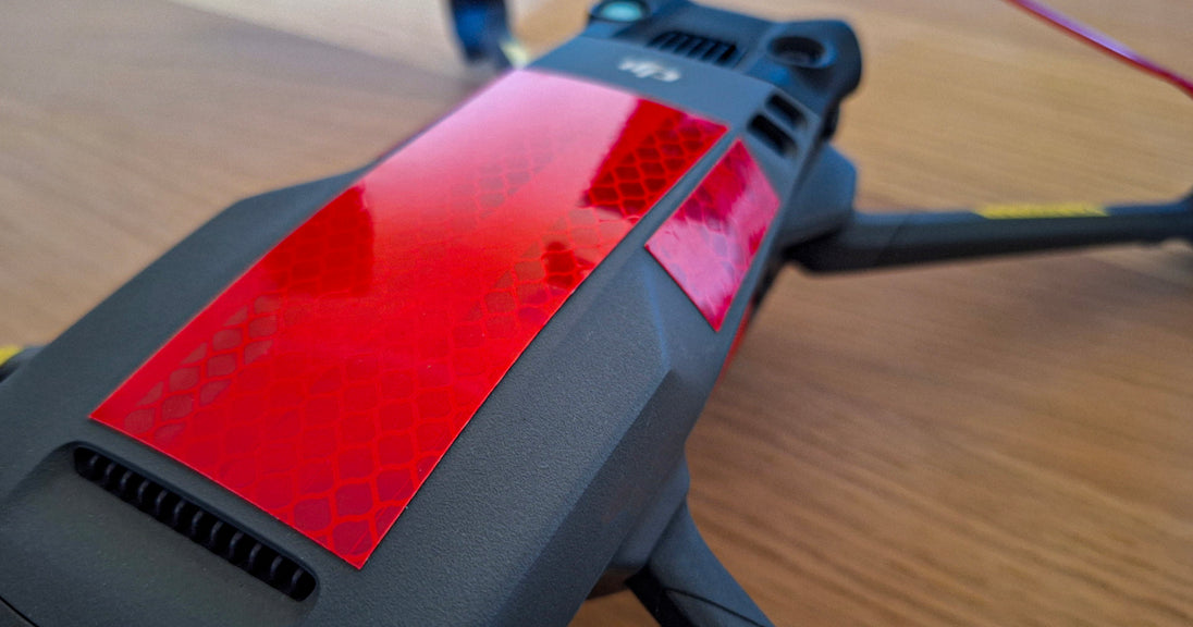 Close-up of anti bird attack reflective red tape applied to a drone for protection against bird strikes.