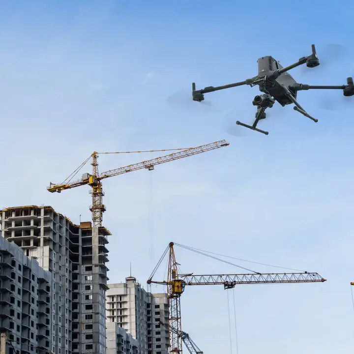 DJI Matrice 400 drone flying over construction site with cranes and buildings under development.