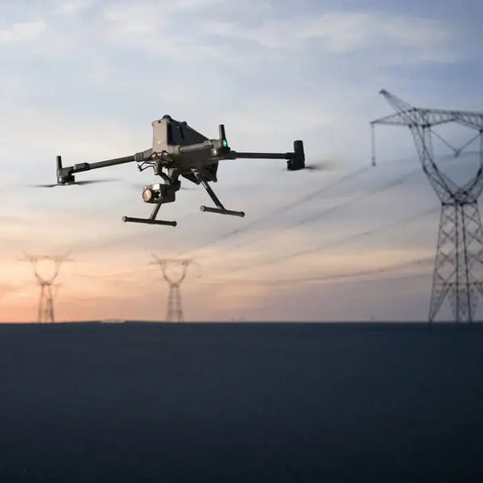 DJI Matrice 400 drone flying against a sunset backdrop with power lines in the background.