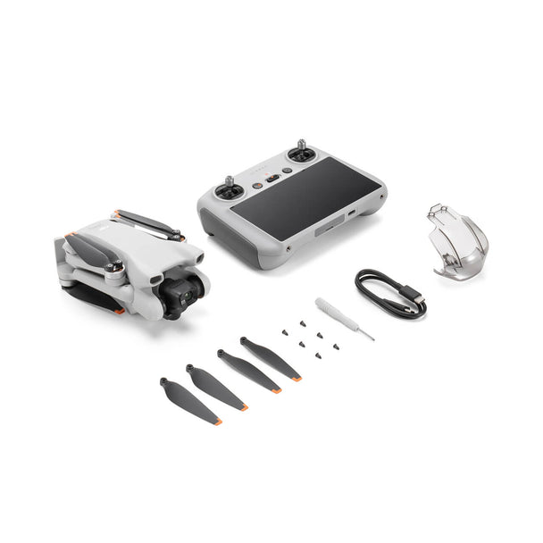 DJI Mini 3 drone and remote controller with accessories including propellers and charging cable.