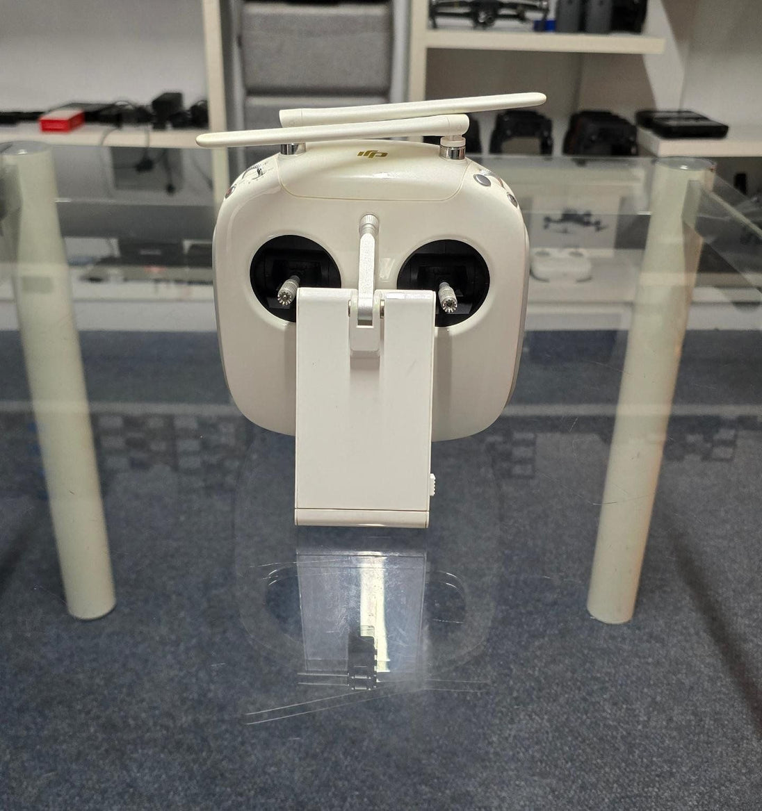 Pre-Owned DJI Phantom 4 Pro V2 Controller displayed on a glass table with no background distractions.