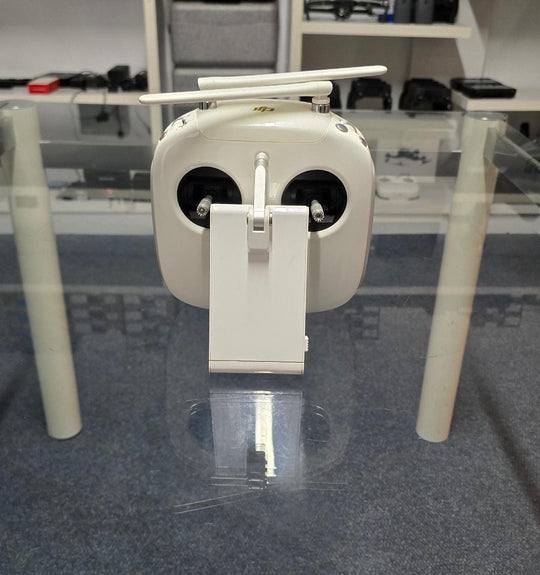 Pre-Owned DJI Phantom 4 Pro V2 Controller displayed on a glass table with no background distractions.