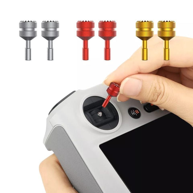 Person inserting a red joystick into the DJI Mini 3 Pro smart remote, featuring titanium and gold joystick options.